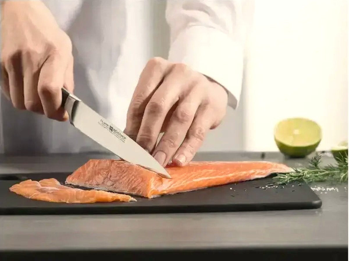 A flexible fillet knife working along a fresh side of fish