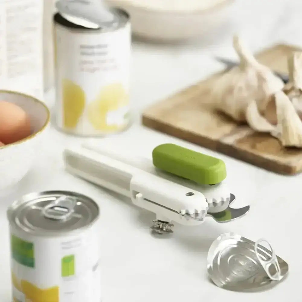 can opener on a counter with an opened can of food