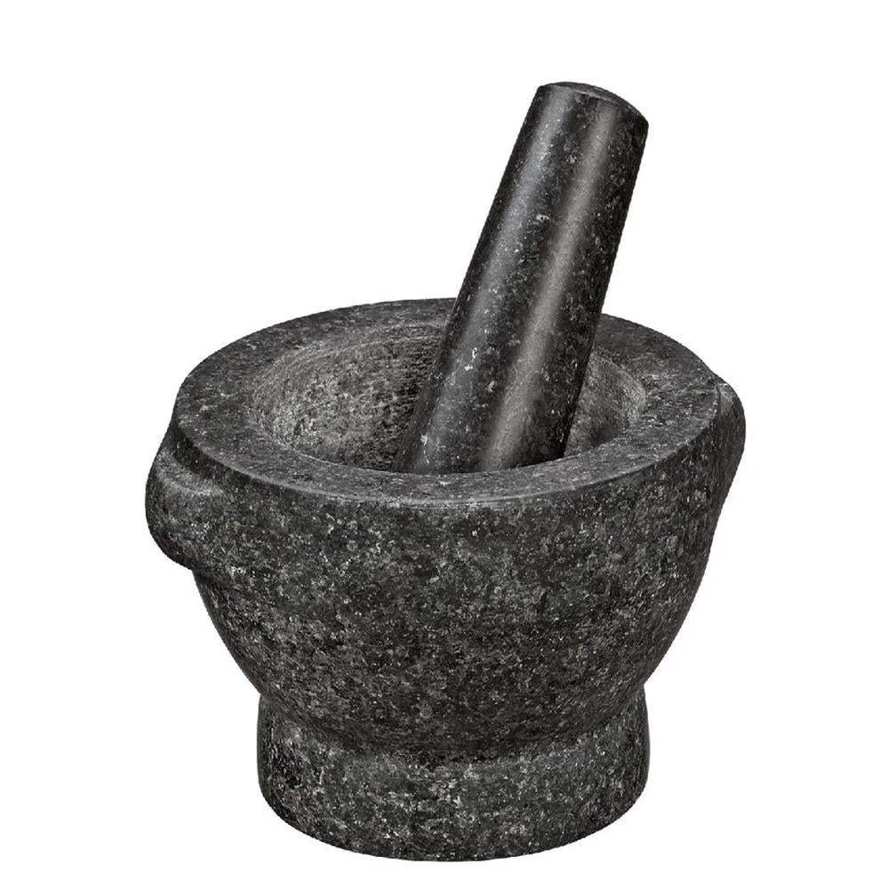 Black stone mortar and pestle on a white background