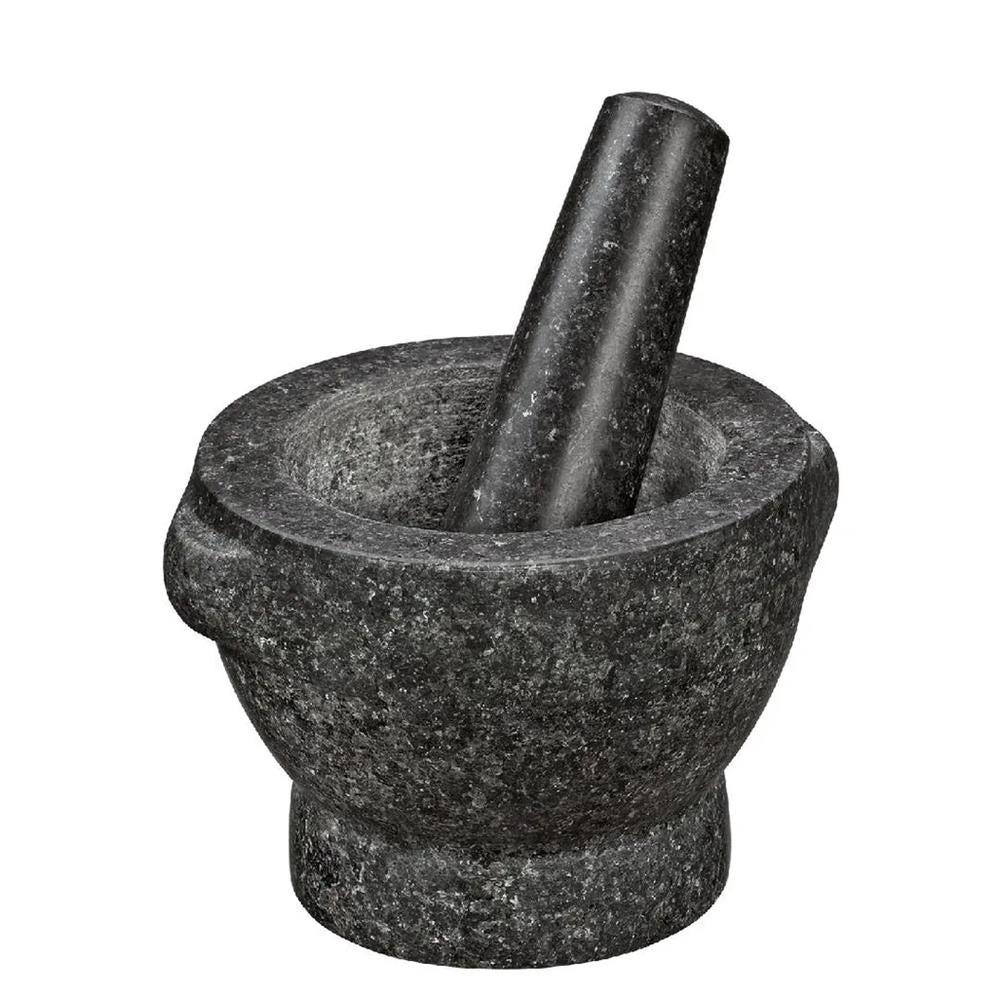 Black stone mortar and pestle on a white background