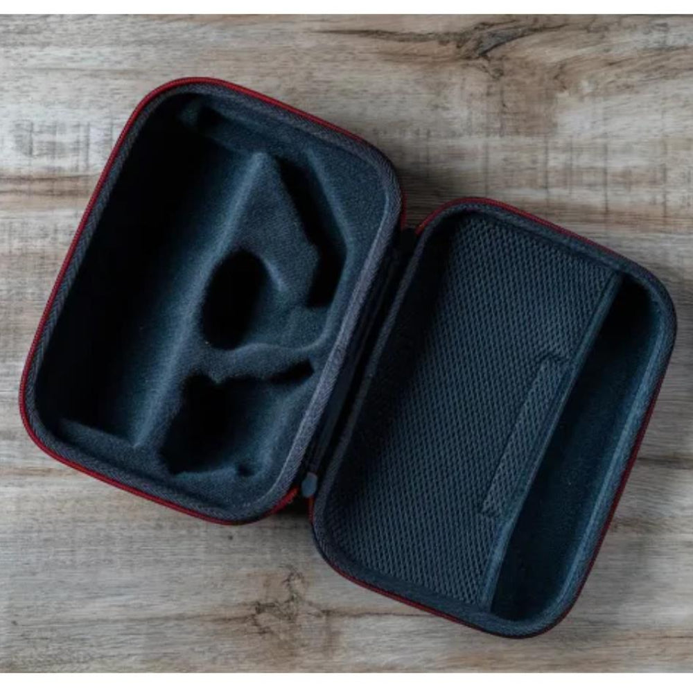 Black carrying case with red interior on a wooden surface