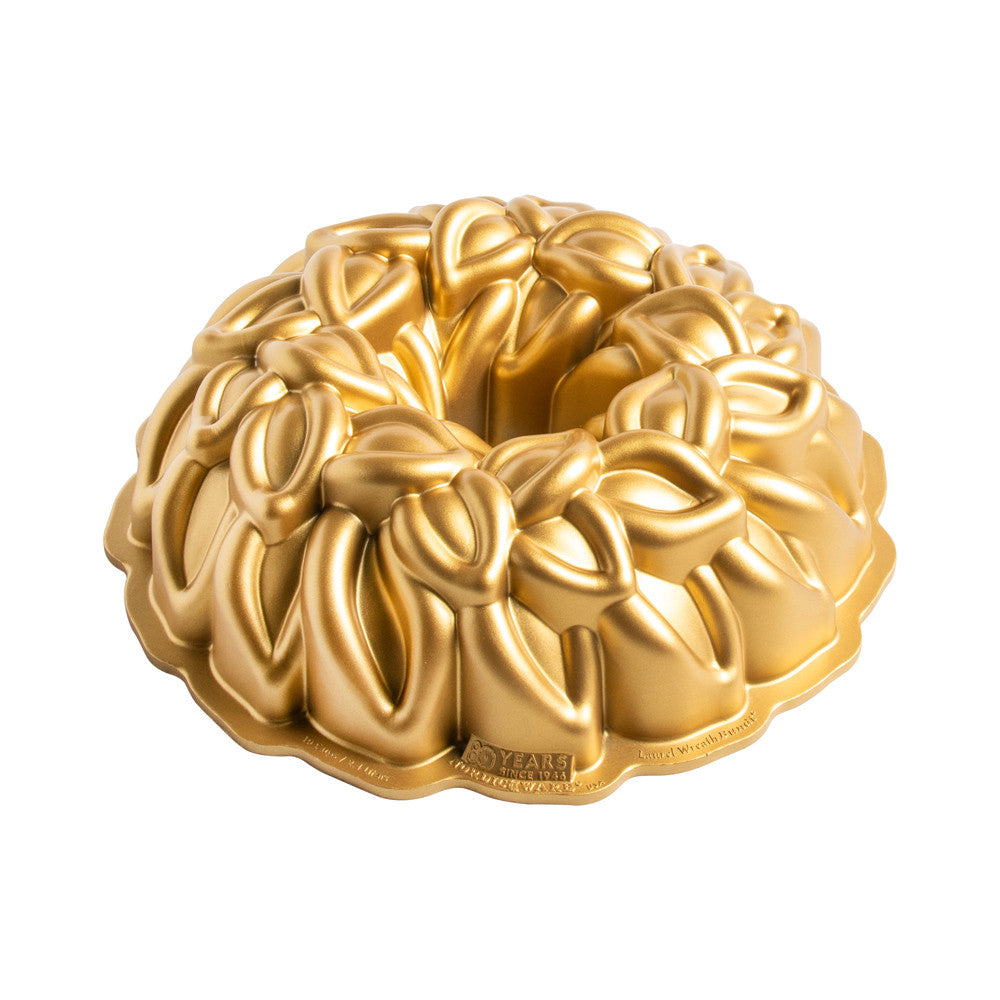 Gold Bundt cake mold on a white background