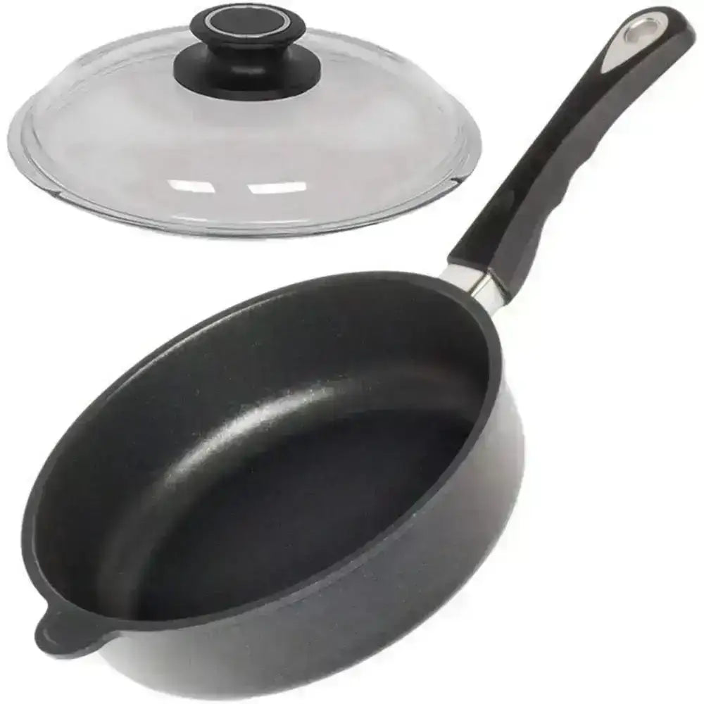 Black frying pan with glass lid on a white background