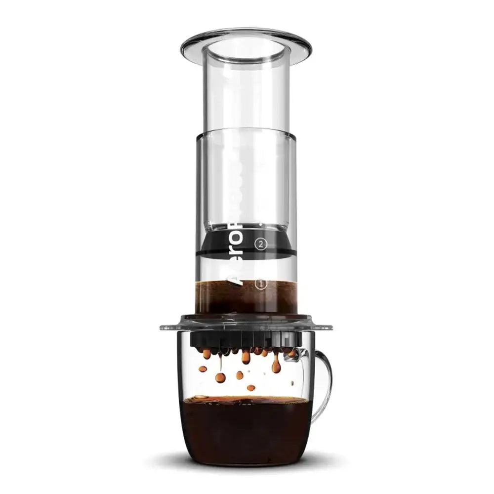 Coffee maker with glass carafe and clear container on a white background