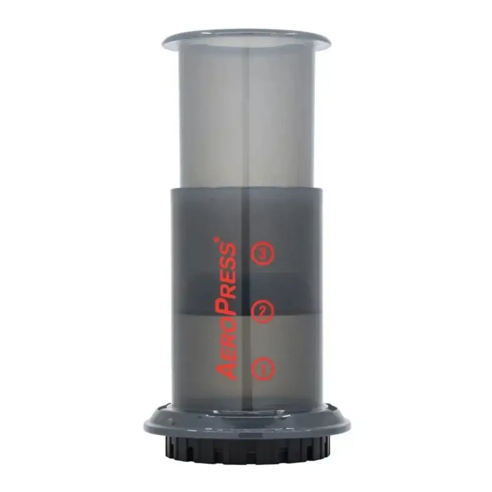 Clear cylindrical coffee brewing device with 'AeroPress' branding on a white background