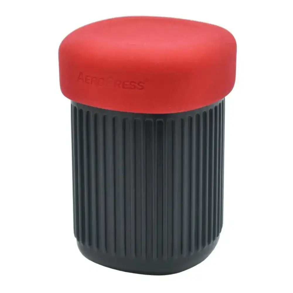 Red and black Aeropress coffee maker on a white background