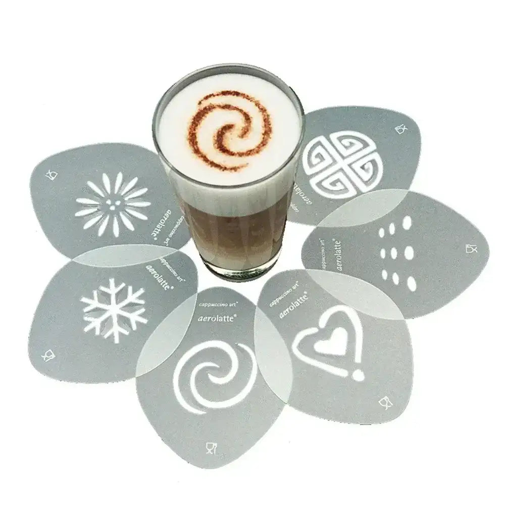 Glass of cappuccino with cinnamon swirl surrounded by decorative stencils on a white background