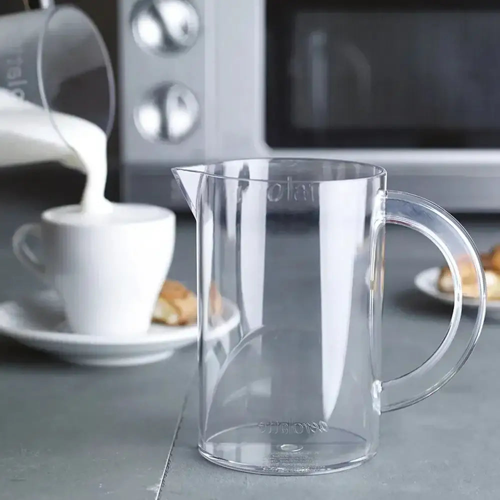 Clear glass pitcher on a kitchen counter with a blurred background