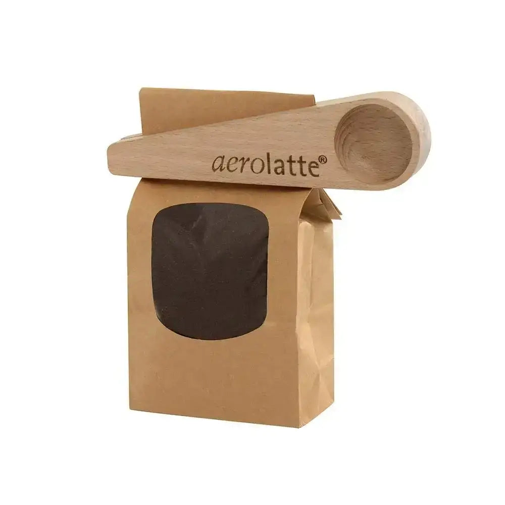 Kraft paper packaging with wooden scoop for Aerolatte product on a white background