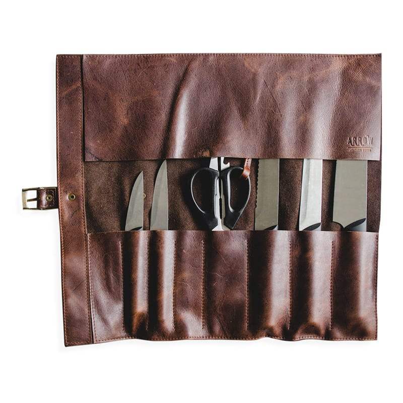 Brown leather tool roll with cutlery on a white background