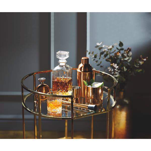 Elegant bar cart with crystal decanter, copper cocktail shaker, and glassware from Cookin Stores