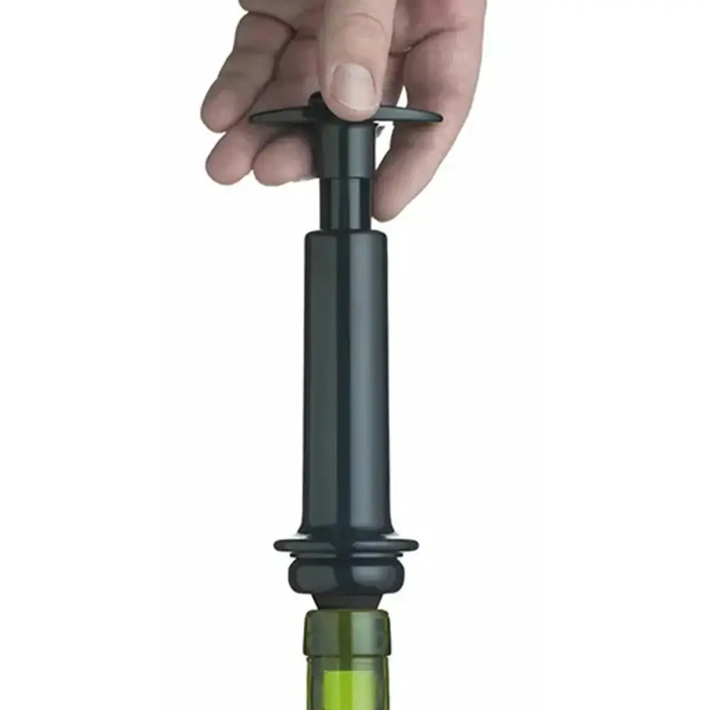 Hand using a black wine bottle stopper on a white background