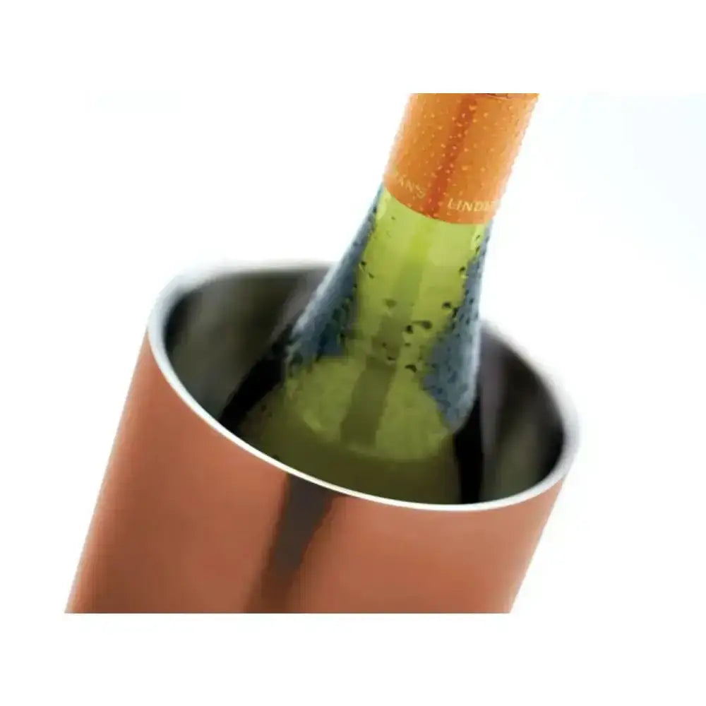 Close-up of a bottle of champagne being poured into a copper bucket.