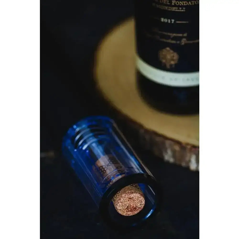Wine bottle with blue foil and cork on a dark background