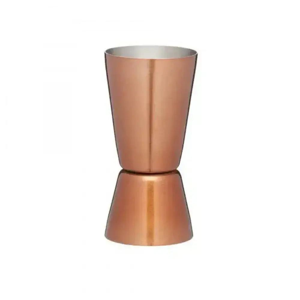 Copper metal jigger on a white background