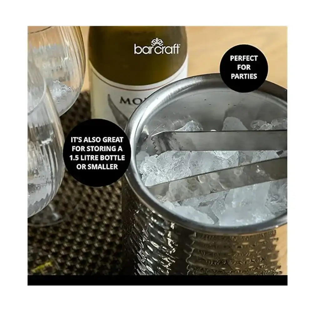 Metal ice bucket with ice, glass, and bottle of Moët & Chandon on a textured surface.