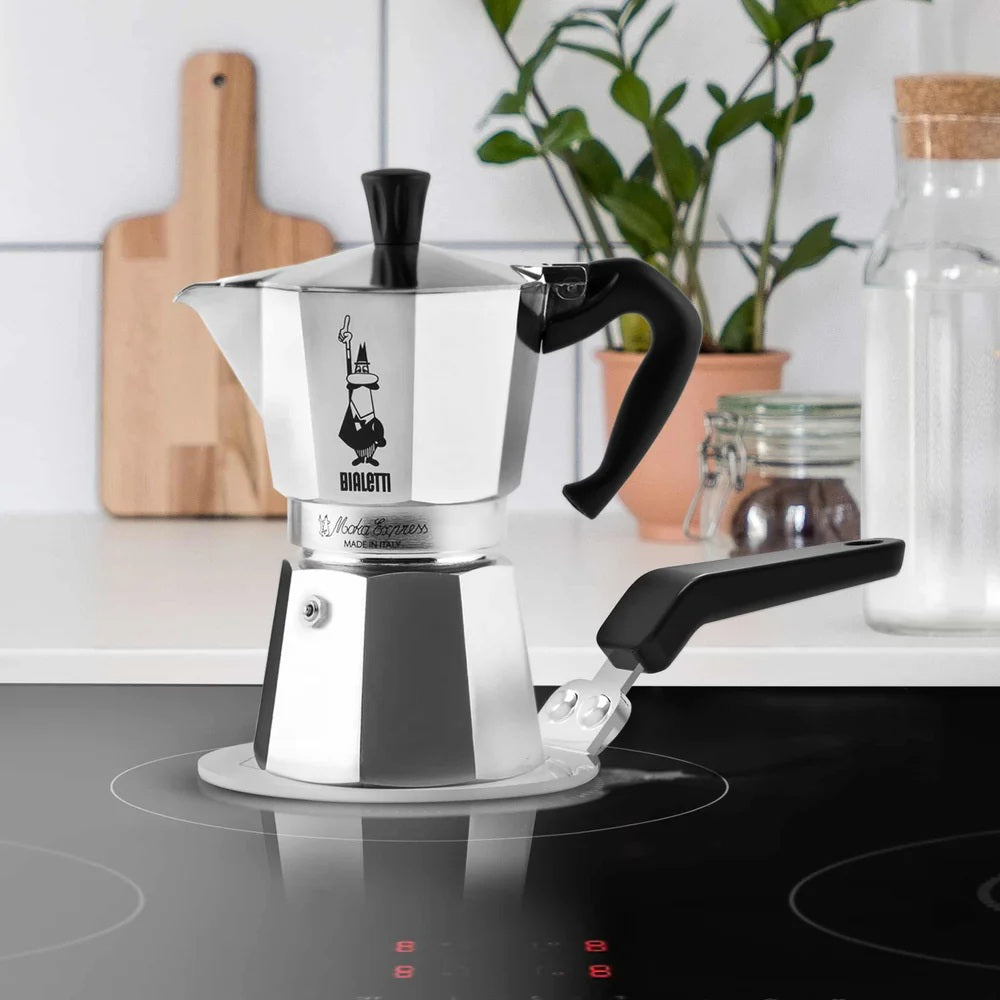 Bialetti coffee maker on a stove with a kitchen background