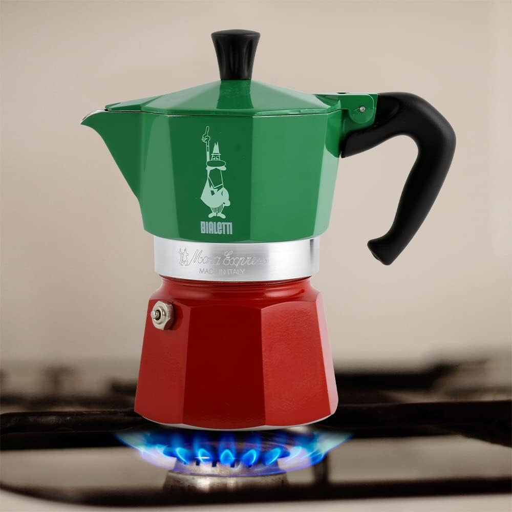 Green and red espresso maker on a stove
