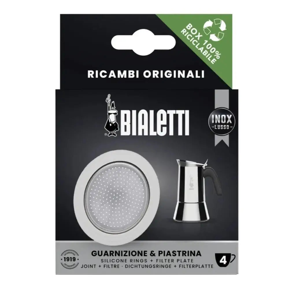 Bialetti coffee maker parts packaging with filter plate and silicone rings on a black background