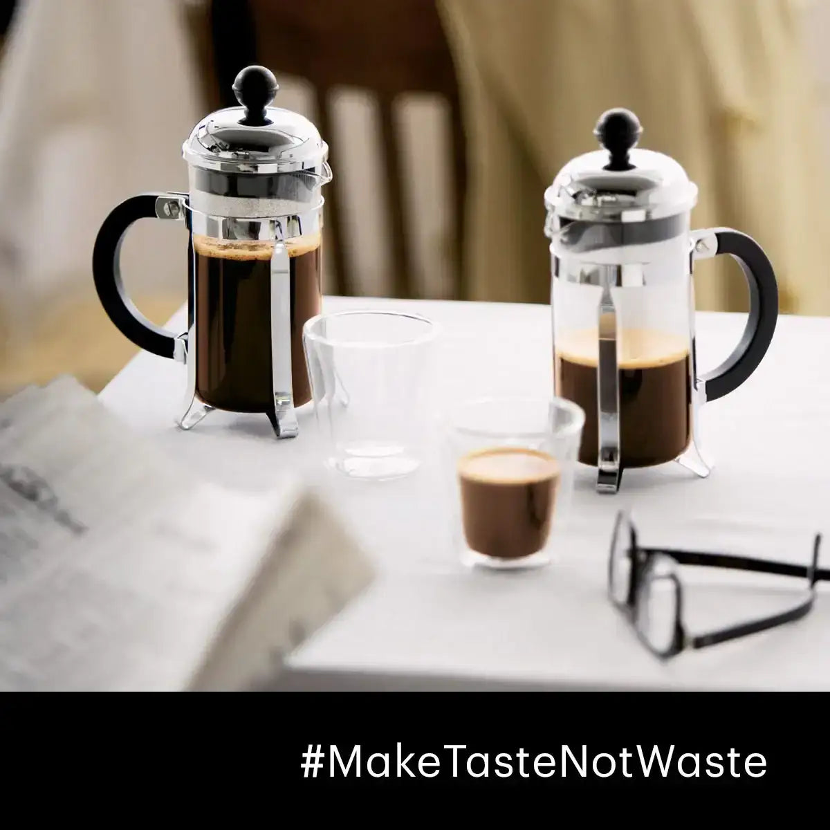Two French press coffee makers with glasses of coffee on a table, with '#MakeTasteNotWaste' text at the bottom.