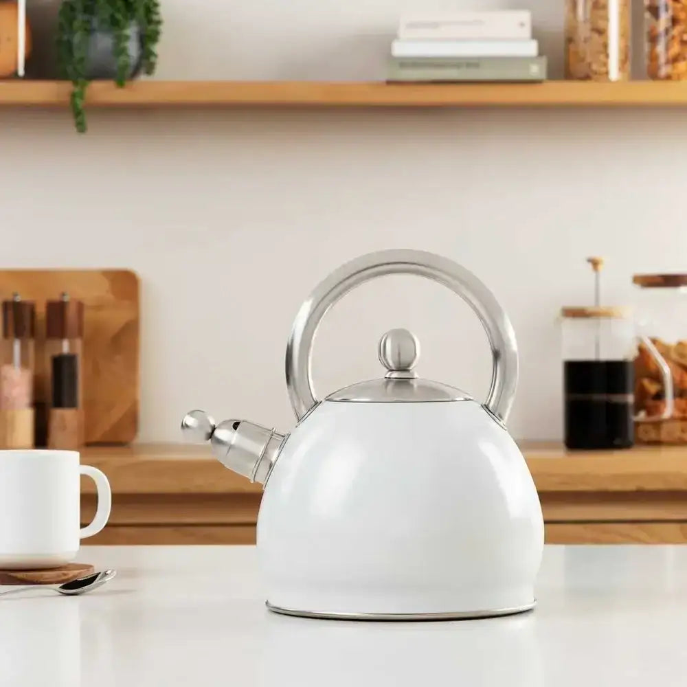 White kettle on a kitchen counter with a blurred background