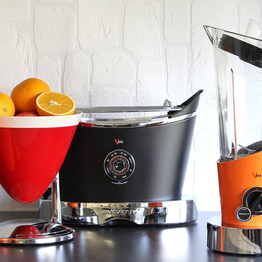 Kitchen appliances on a dark surface with sliced oranges 