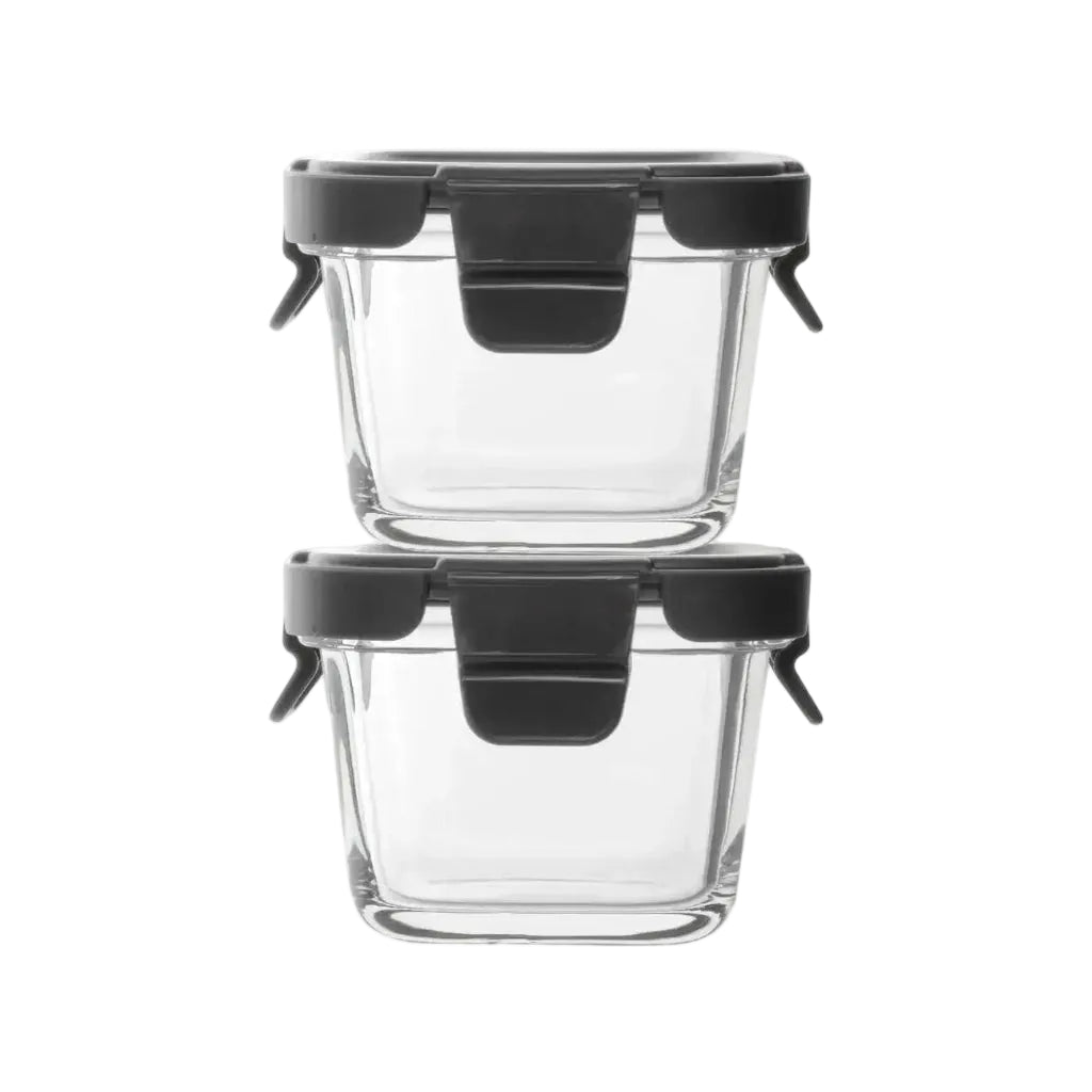 Two clear glass containers with black lids on a white background