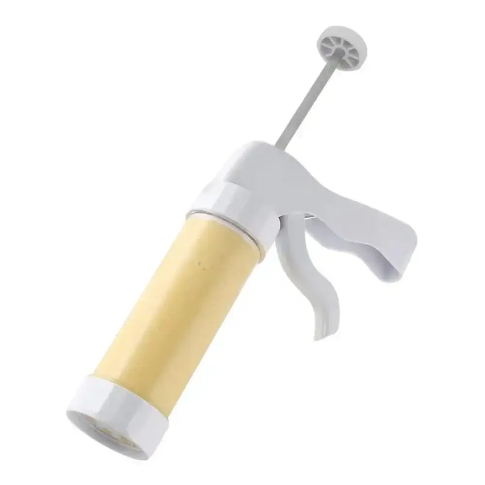 Creative cooking cookie press and icing set with white plastic handle and yellow cylindrical barrel with decorative nozzle