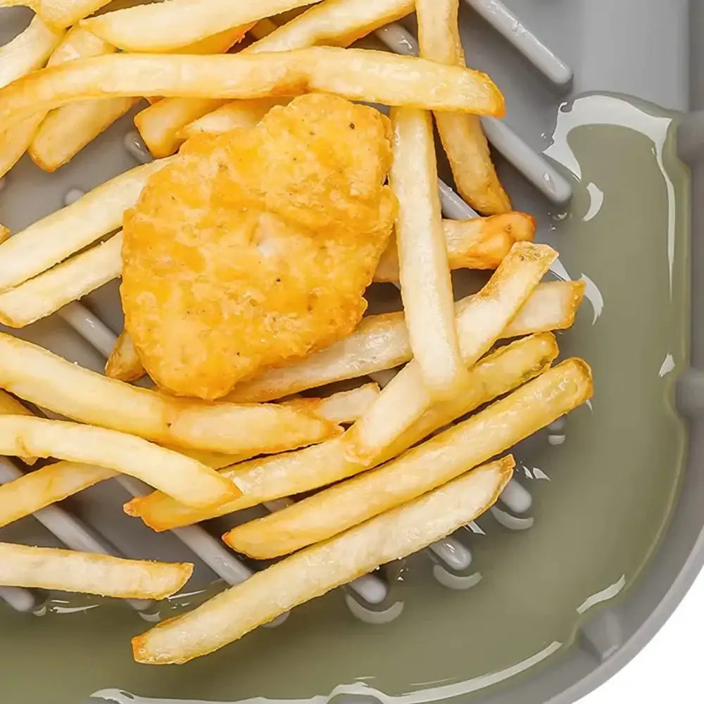 Fish and chips on a silicone surface with oil 