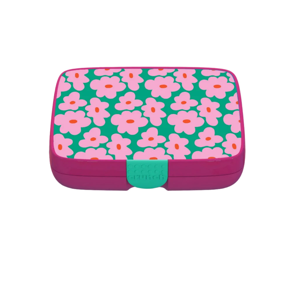 Pink and teal lunchbox with a flower design on a white background