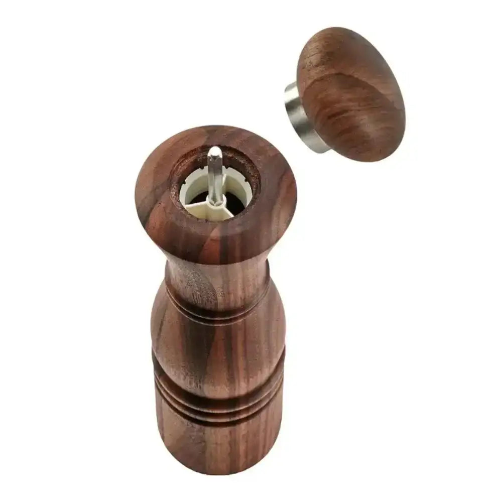 Wooden pepper mill with a wooden top on a white background