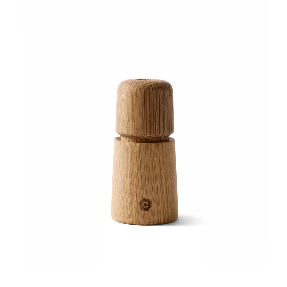 Wooden pepper grinder on a white background