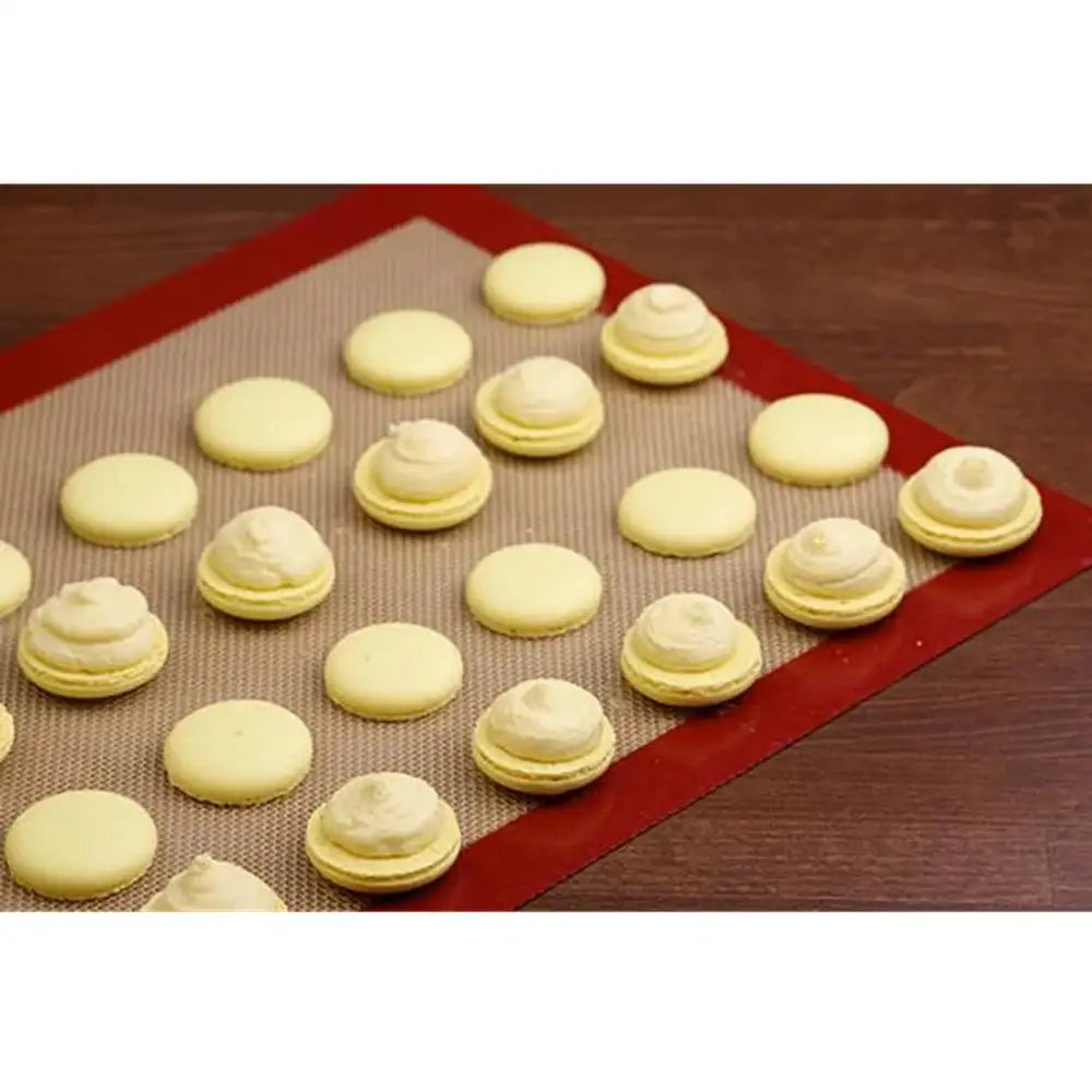 Baked cookies on a silicone baking mat with a wooden surface