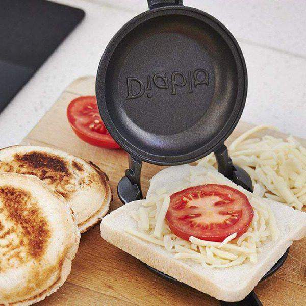 Diablo Titanium Non-Stick Jaffle Iron making cheese and tomato toasties on wooden board