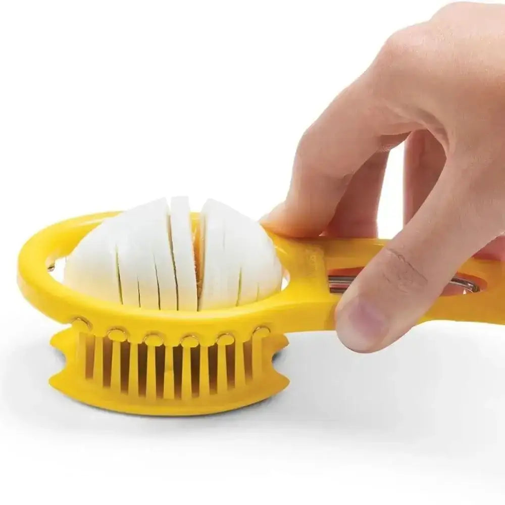 Yellow apple peeler being used to peel a white apple on a white background