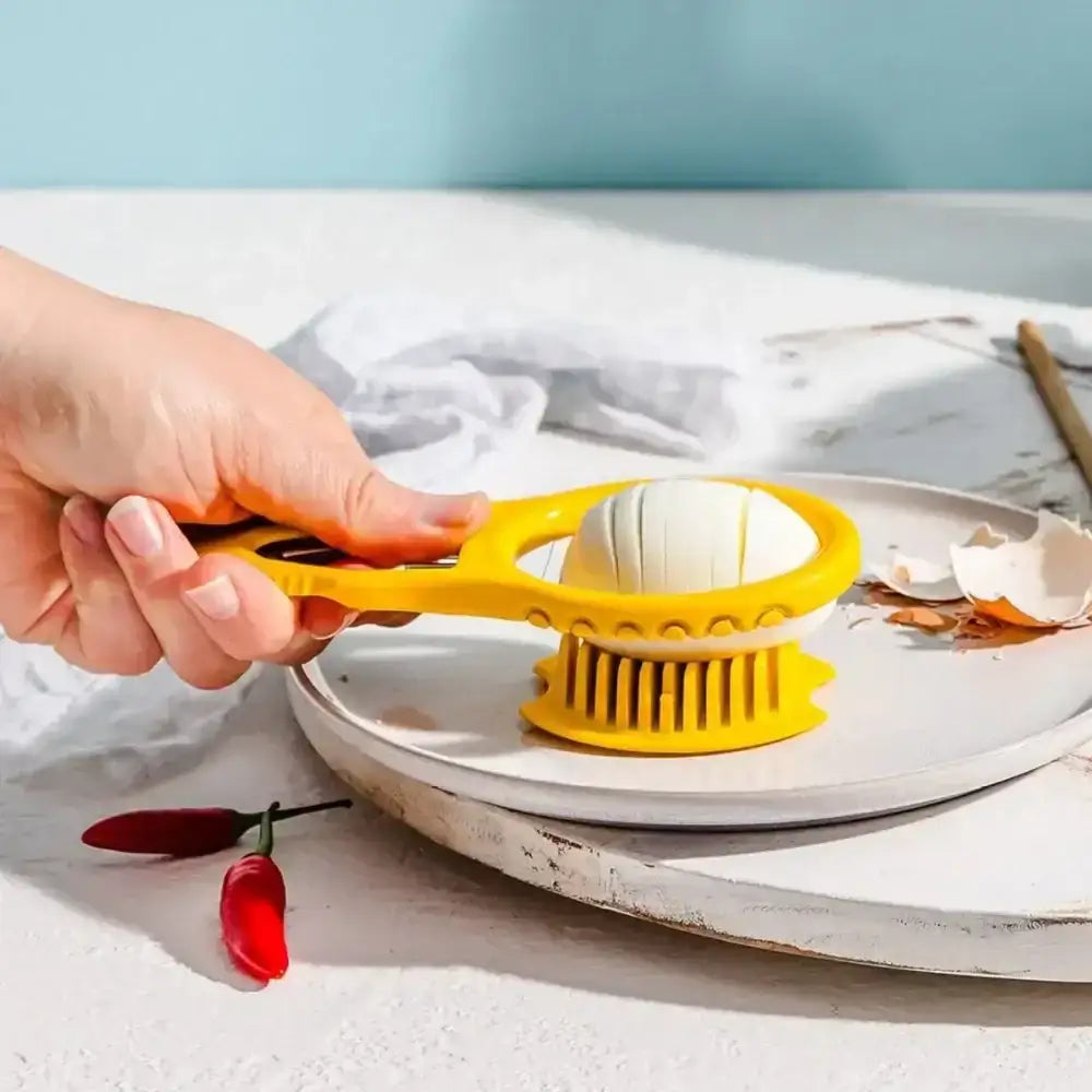 Person using a yellow egg separator on a white plate with a light blue background