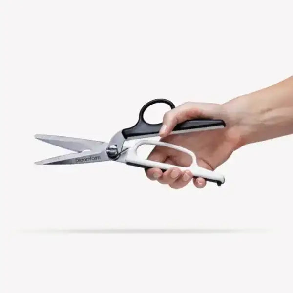 Hand holding Dreamfarm Bishears kitchen scissors, black and white handle, Cookin Stores