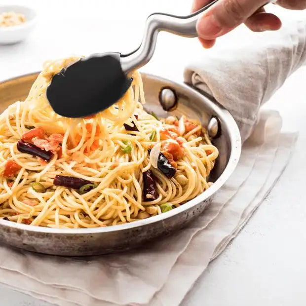Hand using a black spatula to serve spaghetti from a pan on a white background