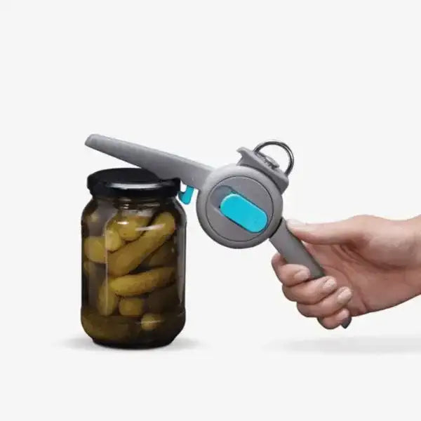 Hand using Dreamfarm Dopener can opener to open a pickle jar, Cookin Stores kitchenware