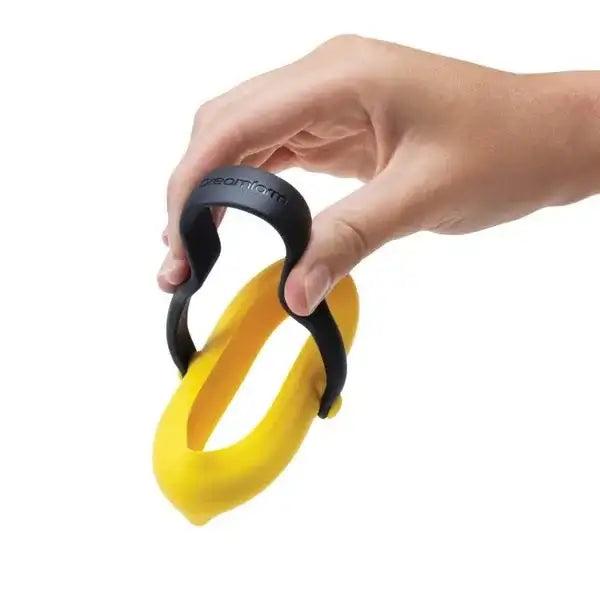 Hand holding Dreamfarm Flegg egg holder, black and yellow, kitchenware at Cookin Stores