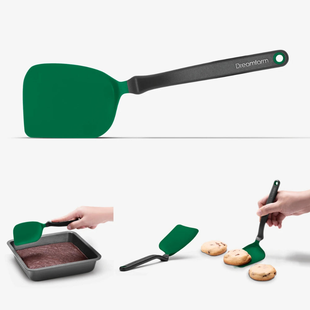 Green spatula with black handle on a white background, used for baking and serving cookies.