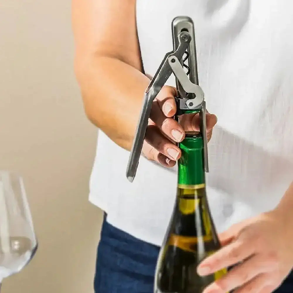 Person using Dreamfarm Winopen mechanical wine opener on a wine bottle, Cookin Stores kitchenware