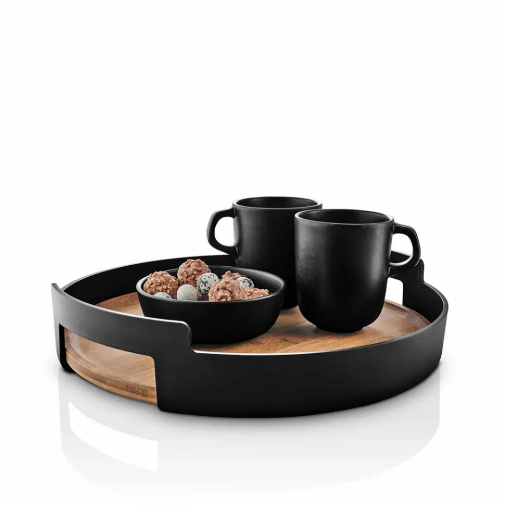 Black mugs and a bowl on a wooden tray with a white background