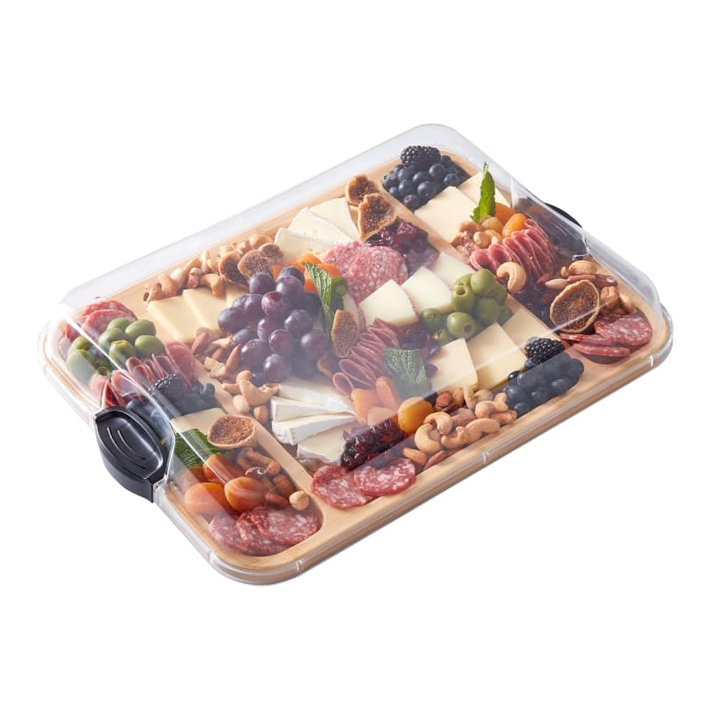 Rectangular platter with assorted fruits, nuts, and meats on a white background