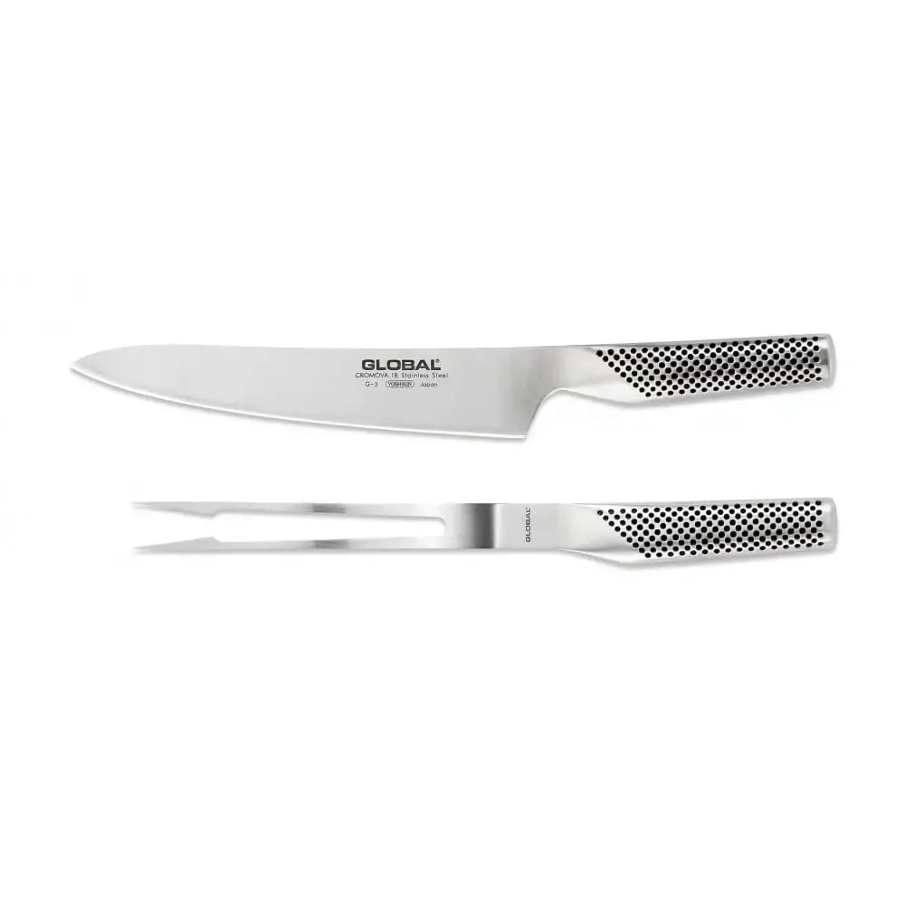 Set of Global chef's knife and carving fork on a white background