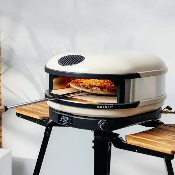 Gozney Arc XL pizza oven on stand baking pizza, indoor kitchenware at Cookin Stores