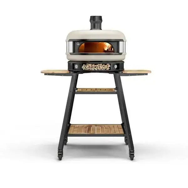 Gozney Dome outdoor pizza oven on stand with wood shelves, available at Cookin Stores.