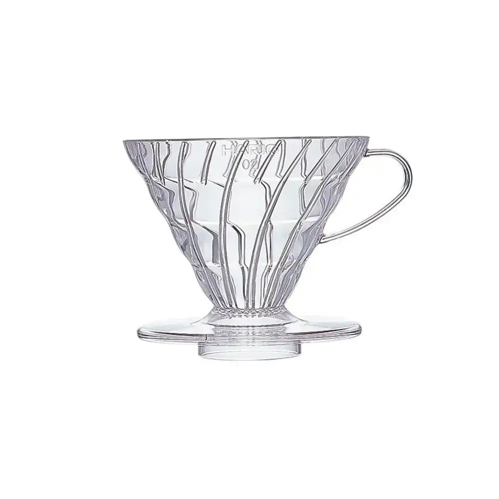 Clear glass coffee dripper with decorative design on a white background