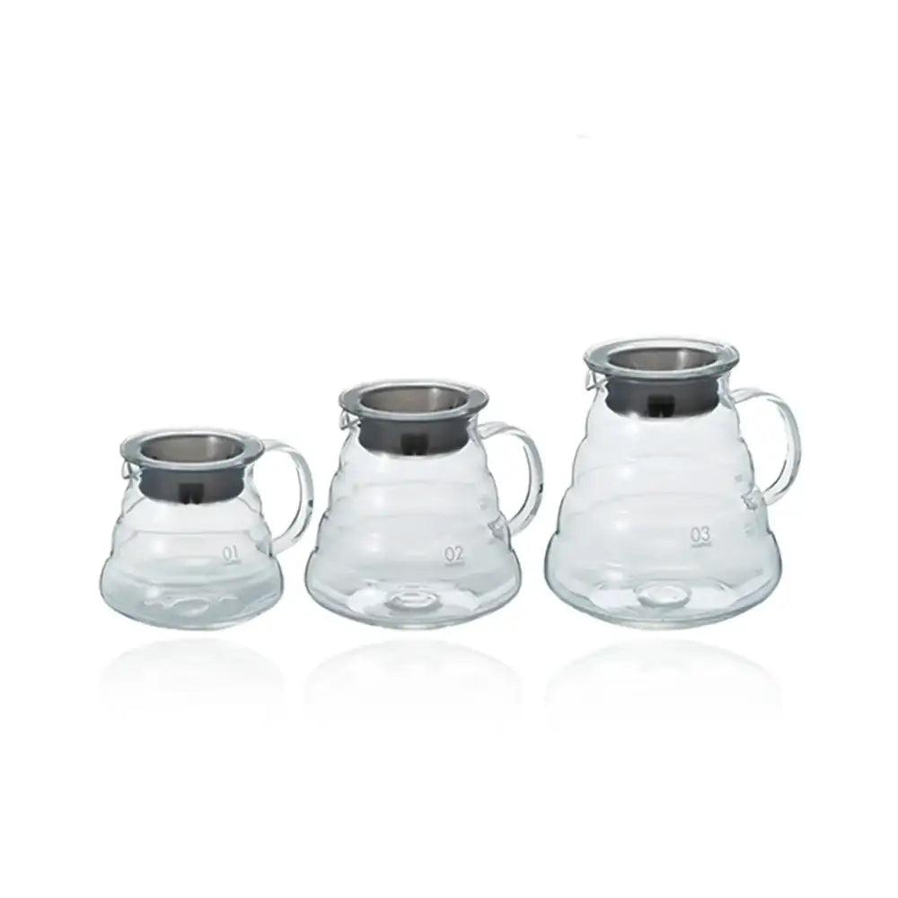 Three glass coffee brewing devices with metal ports on a white background