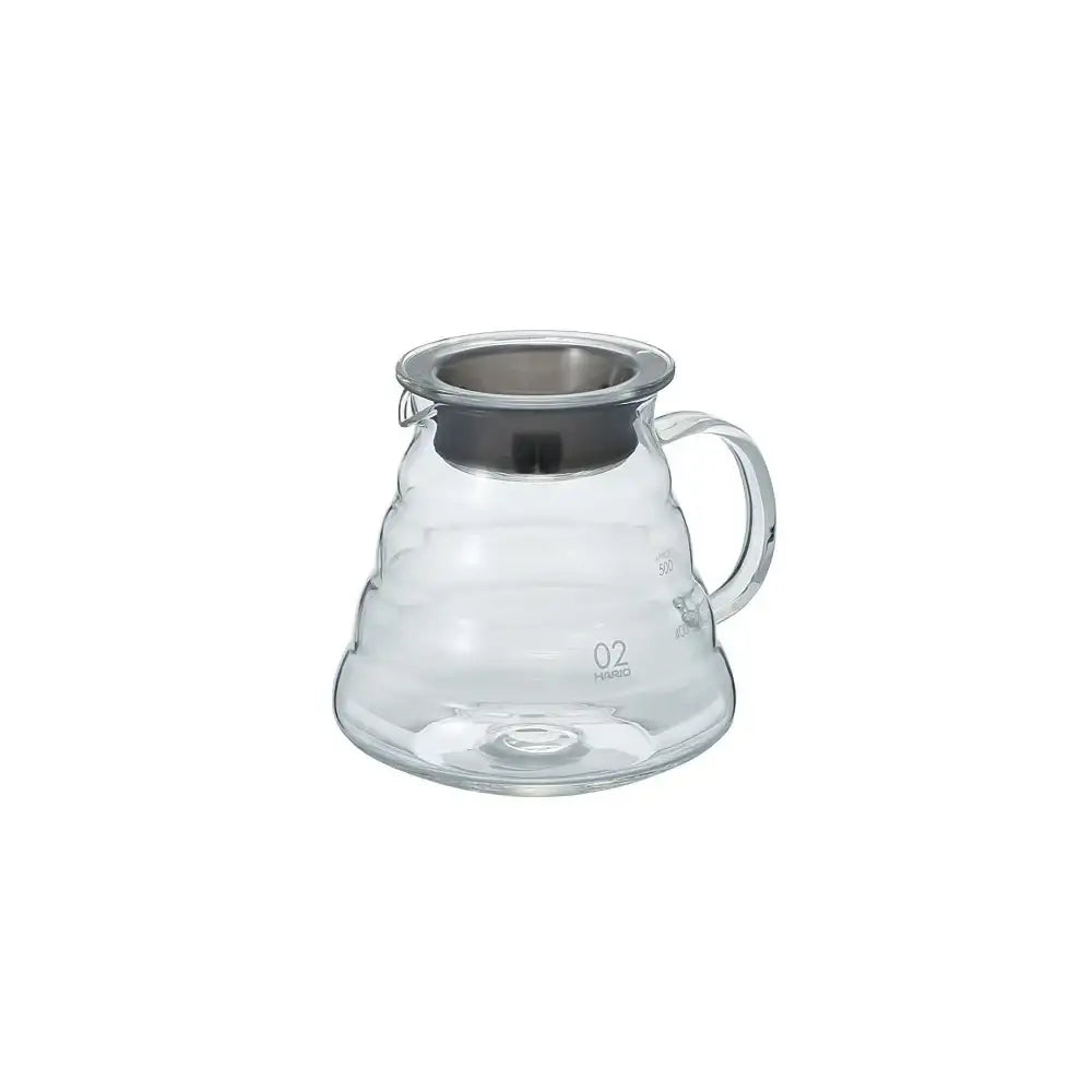 Clear glass coffee server with handle on a white background
